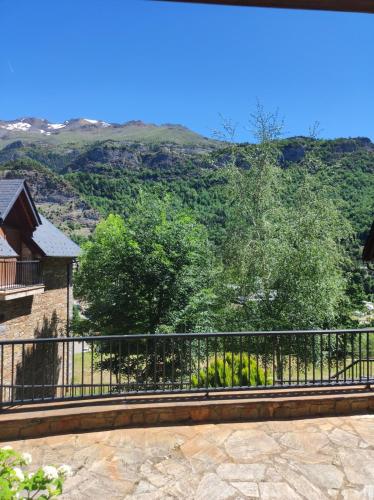 a view of the mountains from the balcony of a house at Los Altos de Escarrilla - tucasaenlospirineos in Escarrilla