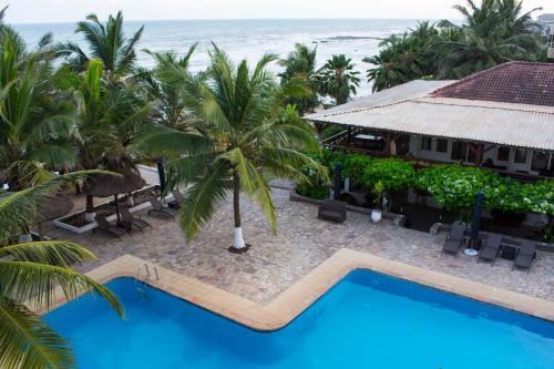 an aerial view of a resort with a swimming pool and the ocean at Best Western Plus Accra Beach Hotel in Teshi