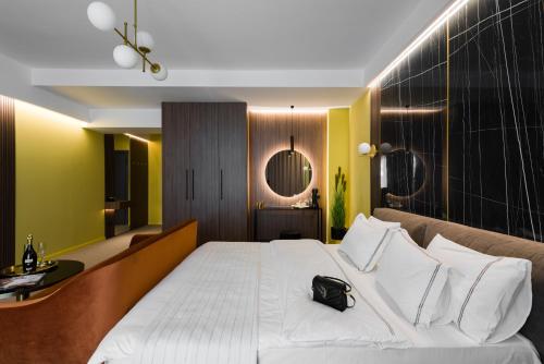 a bedroom with a large bed with a black bag on it at Luxury Sahara Noir Mamaia Nord in Mamaia