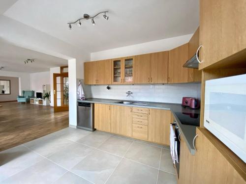 a kitchen with wooden cabinets and a counter top at Ubytování U Pivovaru in Kamenice nad Lipou