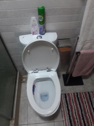 a bathroom with a white toilet and a sink at Professionals Friendly with Work Station PS5 & near Beaches in Lekki