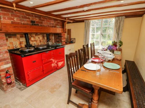 a kitchen with a wooden table and a red stove at 19 Clatterford Shute in Newport