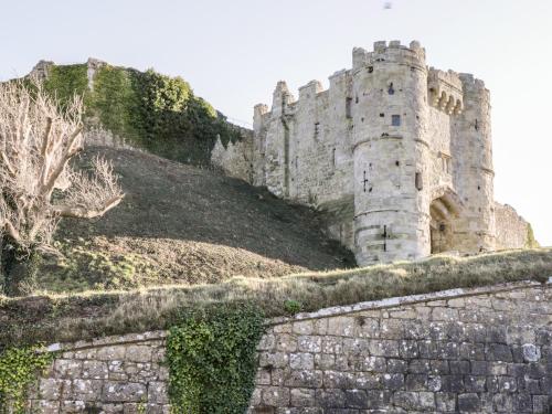 a castle on a hill with a stone wall at 19 Clatterford Shute in Newport