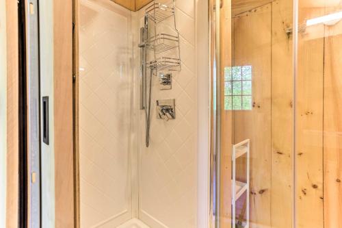a shower with a glass door in a bathroom at Cozy Upstate Studio with Walkill River Views! in New Paltz