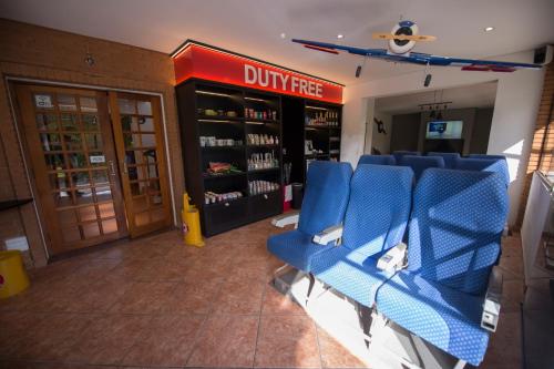 a gym with blue chairs and a drug store at Pousada Constellation Lodge in Campos do Jordão