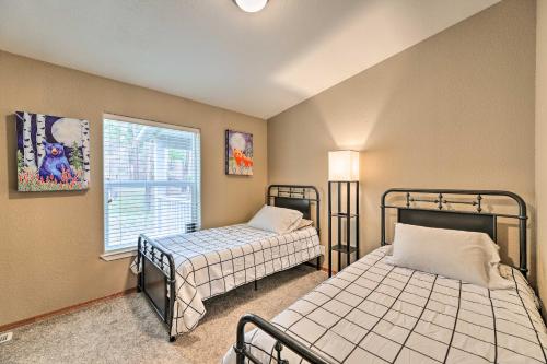 a bedroom with two beds and a window at Rustic Escape with Deck, Hot Tub and Mountain Views in Irwin