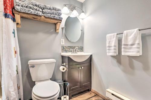 a bathroom with a toilet and a sink and a mirror at Walk to Lake and Beach Pocono Cabin with Fire Pit in Pocono Lake