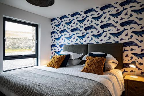 a bedroom with a bed with a blue shark wallpaper at 2 Bed Ground Floor Apartment - 7 Plas in Pistyll