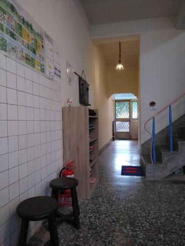 a room with two stools and a staircase in a room at Chentien Changkuang Homestay in Changbin