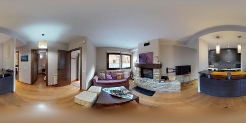 a living room with a couch and a fire place at Los Altos de Escarrilla - tucasaenlospirineos in Escarrilla