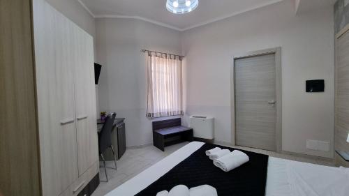 a white room with a bed and a window at Residenza Atena Tropea in Tropea