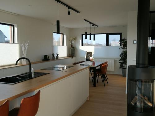 a kitchen with a counter with a stove in it at Akkerland - incl infra-red sauna - excl option hot swimspa from Spring-Halloween -1 bedroom 1-3 pers - 2 bedrooms 4-6 pers in Zonnebeke