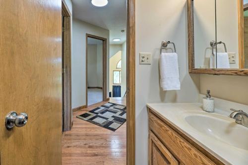 a bathroom with a sink and a mirror at Coloma Escape Pool, Hot Tub Less Than 1 Mi to Lake! in Coloma