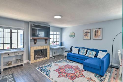 a blue living room with a blue couch and a fireplace at Breezy Monterey Apt Walk to Downtown and Beach in Monterey