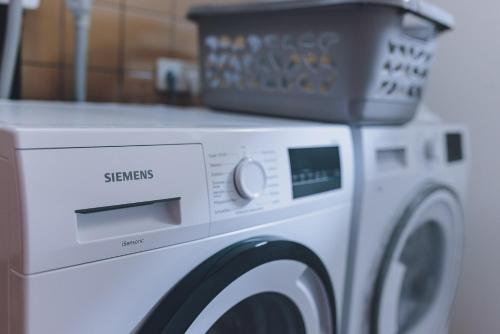a washing machine with a box on top of it at Spa Chalet by we rent in Zell am See