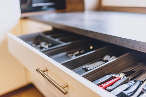a drawer in a kitchen with many knives at Spa Chalet by we rent in Zell am See