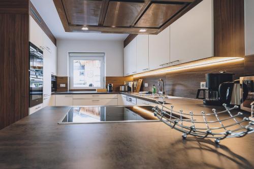 a large kitchen with white cabinets and a counter at Spa Chalet by we rent in Zell am See