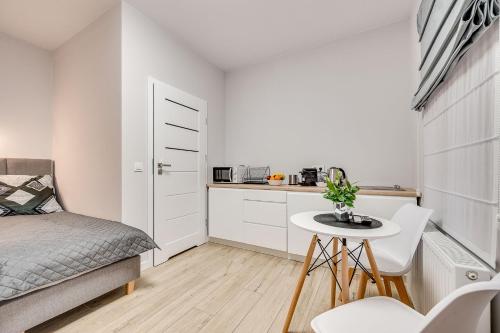 a small bedroom with a bed and a small table at Central Platinum Apartments 25 in Rybnik