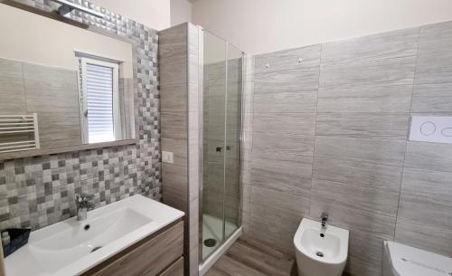 a bathroom with a sink and a toilet and a shower at Residenza Atena Tropea in Tropea