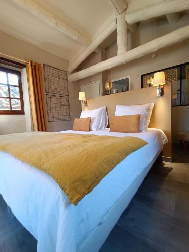 a large bedroom with a large bed with two pillows at La Magnanerie de Camias in Saint-André-de-Majencoules