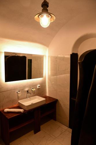 a bathroom with a sink and a mirror at Grandma's Homes in Imerovigli