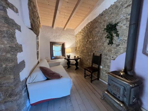 a living room with a couch and a stove at Agriturismo B&B Luna di Quarazzana in Fivizzano Tuscany in Fivizzano