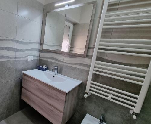 a bathroom with a sink and a mirror at Residenza Atena Tropea in Tropea