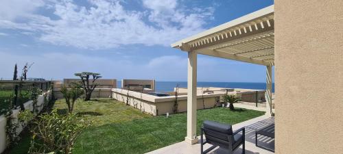 a house with a patio with a view of the ocean at Salt n Blue Villa Palase in Palasë