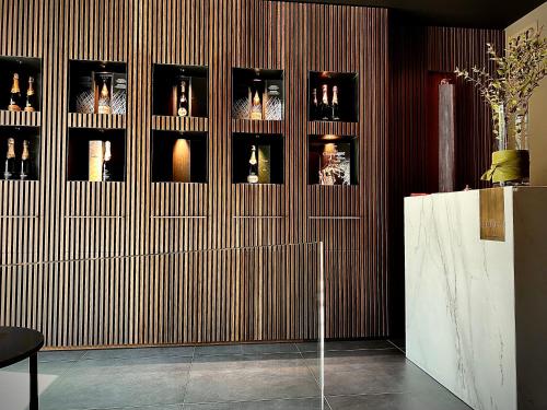 a room with a wall with many bottles on it at DIMORA1934 Relax&Comfort in Tirano