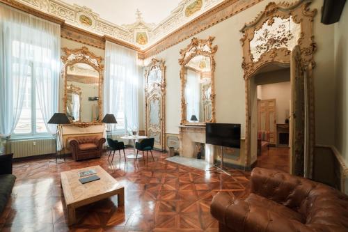 a living room filled with furniture and a large window at Royal Palace Hotel in Turin