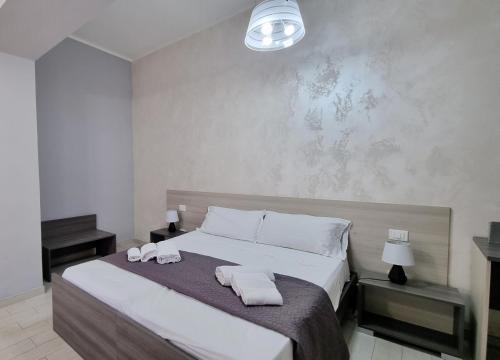 a bedroom with a large bed with towels on it at Residenza Atena Tropea in Tropea