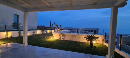 a house with a view of the ocean at night at Salt n Blue Villa Palase in Palasë