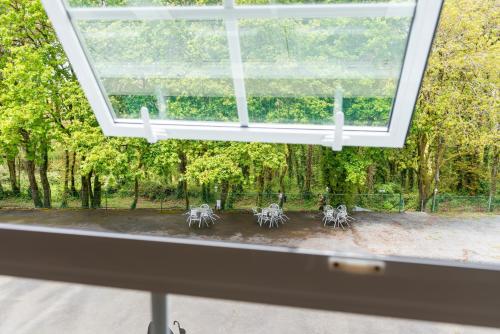 a window with a view of a garden at Hotel Castro in Santiago de Compostela