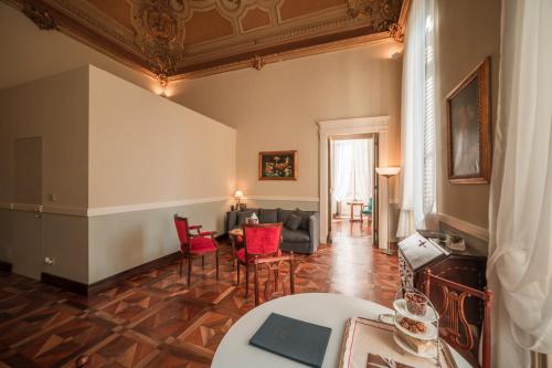 a living room with red chairs and a couch at Royal Palace Hotel in Turin