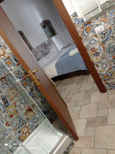 a staircase leading to a bedroom with a bed at monolocale Angelene in Vitorchiano