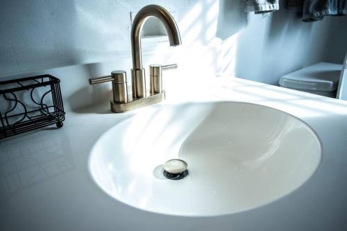 a white bathroom sink with a silver faucet at Charming 1932 Craftsman - The Bohannon House in Luray