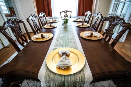 a long wooden table with chairs and plates and napkins at Charming 1932 Craftsman - The Bohannon House in Luray