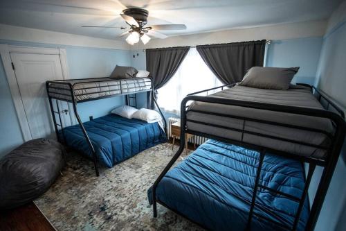 a bedroom with two bunk beds and a ceiling fan at Charming 1932 Craftsman - The Bohannon House in Luray
