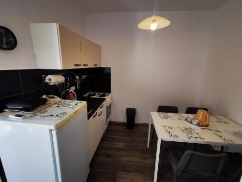 a kitchen with a counter and a table with a counter top at Apartman Smokva in Vodice