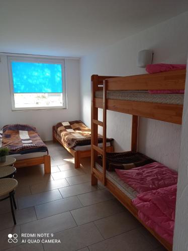 a room with two bunk beds and a window at LKS Charzykowy 4 in Charzykowy