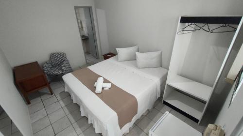 מיטה או מיטות בחדר ב-Pousada Cecosne