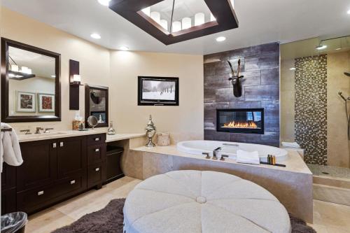 a large bathroom with a tub and a fireplace at Flagstaff #202 in Park City