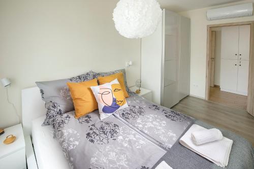 a white couch with pillows on it in a room at TREND BA HOME Apartman in Balatonalmádi