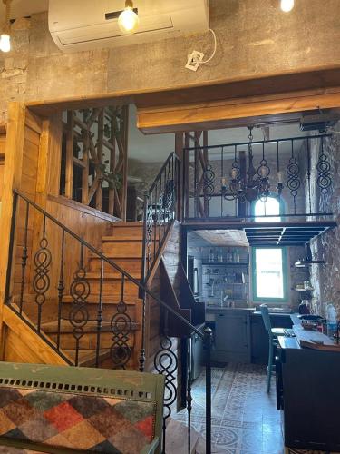 a living room with a staircase and a dining room at Alf leila wa leila boutique in Haifa
