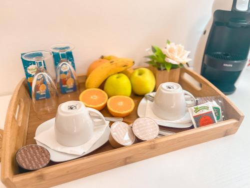 a wooden tray with a tea set and fruit on it at Pension As Burgas Ii in Caldas de Reis