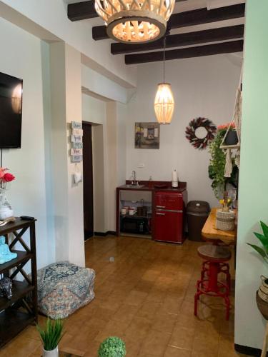 a living room with a table and a red cabinet at The Suites & Vintage Apartment at Casa Of Essence in heart of Old San Juan in San Juan