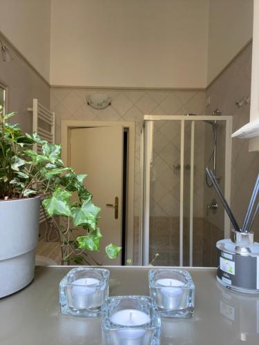three glasses sitting on a counter in a bathroom at Tamborino Terrace Apartment - Salento Apartments Collection in Lecce