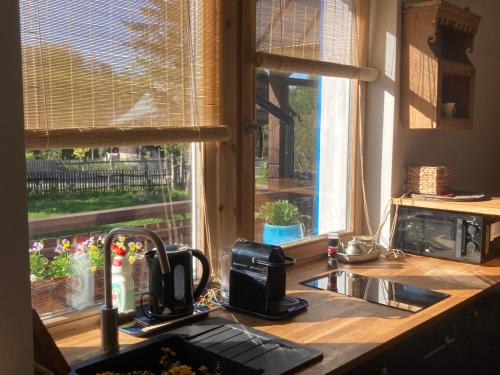 a kitchen counter with a sink and a window at Chata pod Rogową Apartamenty in Javorina