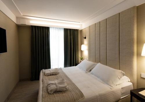 a hotel room with a bed with towels on it at Ceccarini 9 home suite home in Riccione