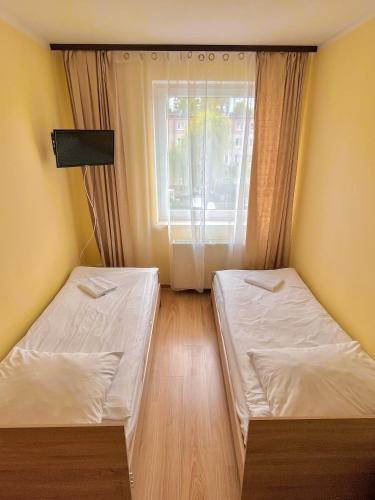 Postel nebo postele na pokoji v ubytování Hostel DV Morski - z prywatnymi łazienkami
